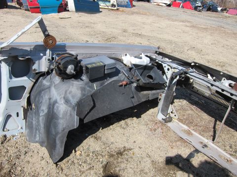 1991 Ford LTD Crown Victoria - Disassembled car firewall and HVAC system components are visible in a junkyard setting.