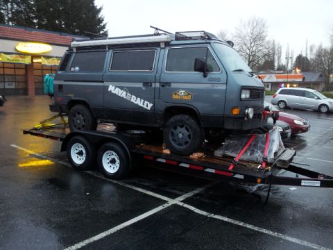 2008 GMC Sierra 3500 - A gray Volkswagen Vanagon with "MAYA RALLY" graphics is loaded onto a trailer.