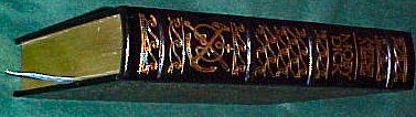 2003 Ford Expedition - A book spine with decorative gold lettering and a bookmark is visible.