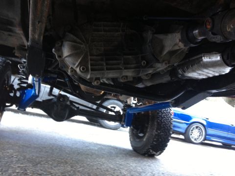 1996 Ford F-150 - The photo shows the undercarriage of a vehicle, focusing on the transmission and suspension components.