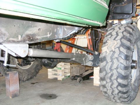 1967 Ford F-250 - Undercarriage view of a modified truck, showing heavy-duty suspension and large tires.