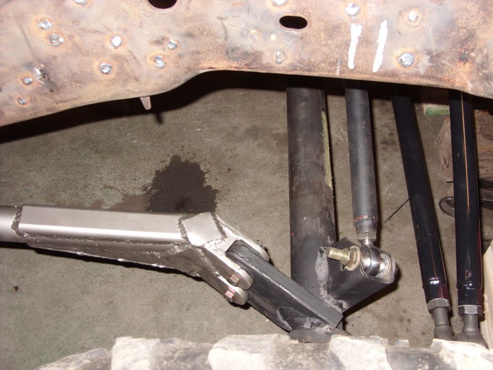 Close-up of custom suspension linkage and frame welding on a vehicle