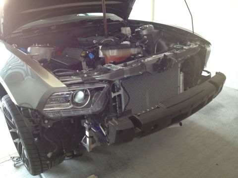2013 Ford Mustang - Front view of a gray 2010 Ford Mustang with its hood open and bumper removed, revealing the engine and radiator assembly.