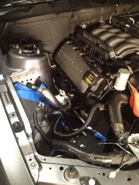 2013 Ford Mustang - Engine bay of a Ford vehicle, showing the V8 engine and associated components.