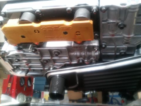 1994 Ford Bronco - A close-up view of a transmission part, possibly from a Ford vehicle, with visible fluid.