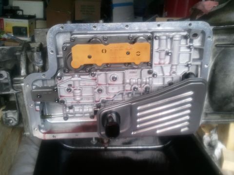 1994 Ford Bronco - Close-up view of an open automatic transmission pan, revealing the valve body and filter assembly.