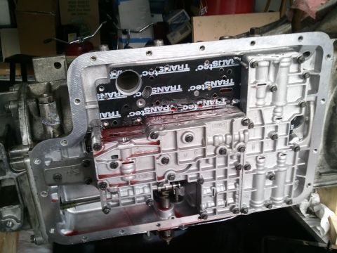 1994 Ford Bronco - Transmission valve body removed for service, showing internal components and gasket.