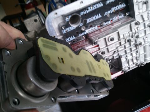 1994 Ford Bronco - Close-up of a transmission valve body, showing internal components and some red fluid.