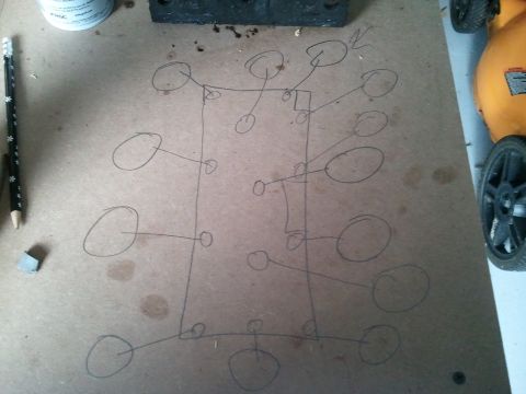 1994 Ford Bronco - rough hand-drawn pencil sketch of ovals connected by lines on a piece of cardboard, not a formal technical document.