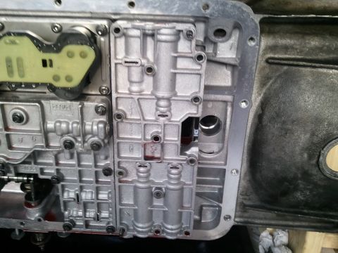 1994 Ford Bronco - This is a close-up view of an automatic transmission valve body, showing its intricate internal components and solenoids.
