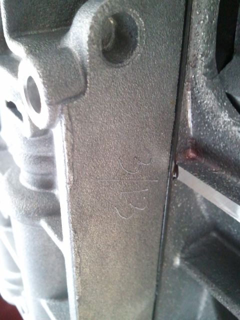 1994 Ford Bronco - A close-up view of a metal component shows stamped numbers, possibly a part identification.