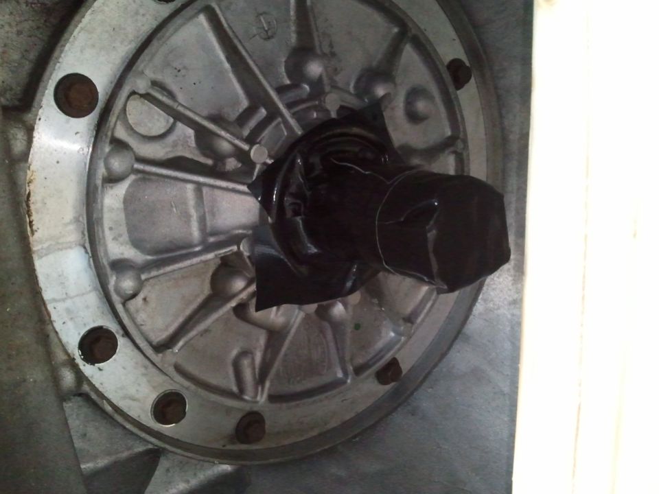 Close-up of a metal component with a black-taped shaft sticking out