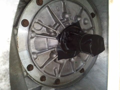 1994 Ford Bronco - Close-up of a transmission component, likely a flange and shaft, with black tape covering part of the shaft.