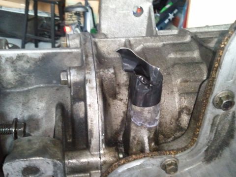 1994 Ford Bronco - Transmission housing shows a makeshift repair using black tape on a protruding component.