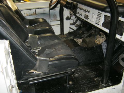 1970 Ford Bronco - The interior of a 1970 Ford Bronco features black bucket seats, a roll cage, and a functional dashboard.