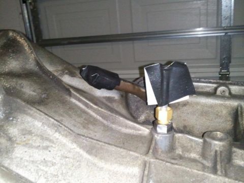 1994 Ford Bronco - Close-up view of a transmission housing with a sensor and tubing, likely for a fluid pressure reading.