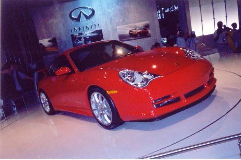 1992 Ford Crown Victoria - A red sports car is displayed at an auto show with the Infiniti logo visible.