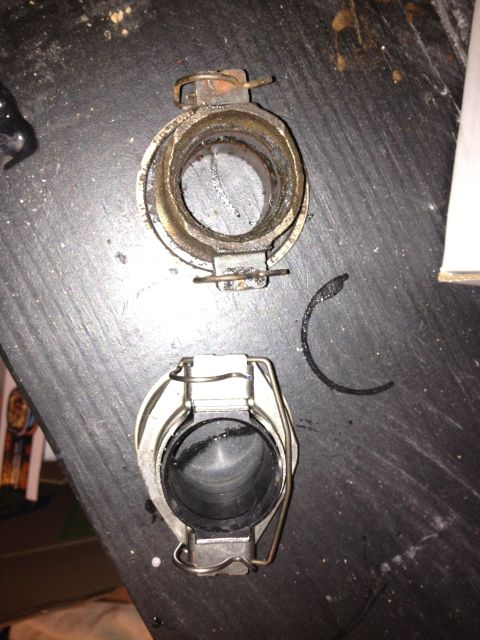 2005 Jeep Wrangler - A worn clutch release bearing and fork assembly is shown next to a new one.