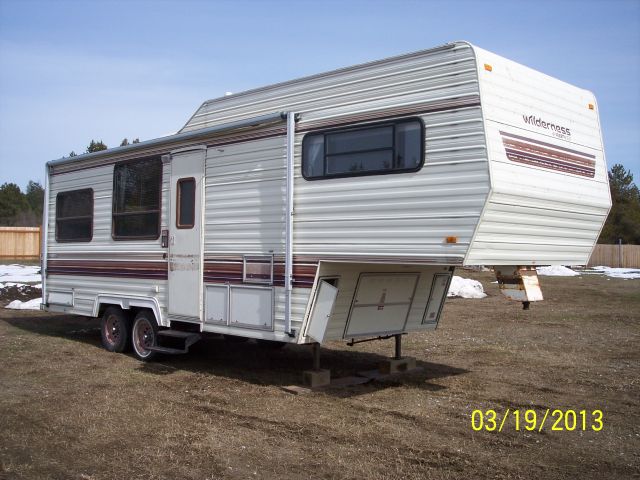 Fifth wheel camper with 'Wilderness' branding on the front