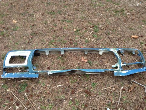 1979 Ford Bronco - Front grille assembly, possibly from a 1978 Ford Bronco, shown on the ground.
