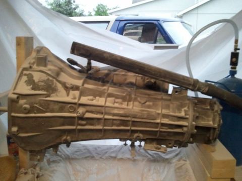 1994 Ford Bronco - A transmission part is shown in detail, with a blue truck visible in the background.