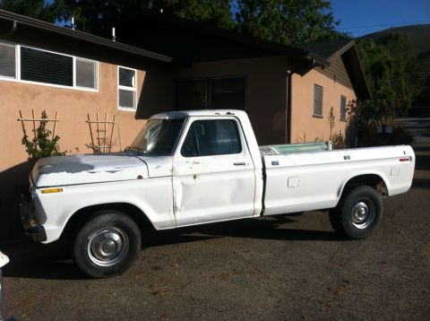 1977 Ford F-350 - This white 1977 Ford F-350 pickup truck is shown from the side, parked in front of a house.