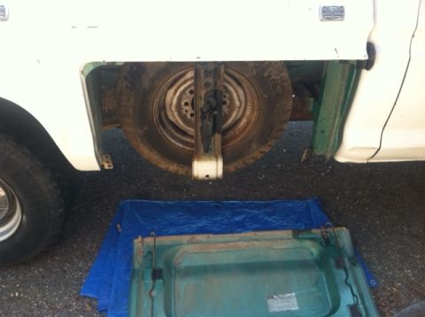 1977 Ford F-350 - The spare tire well and removed tailgate of a white 1977 Ford F-350 pickup truck.