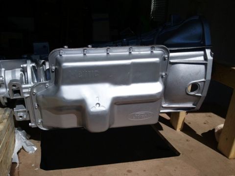 1994 Ford Bronco - A silver transmission pan with a Ford logo is shown, likely a replacement part.