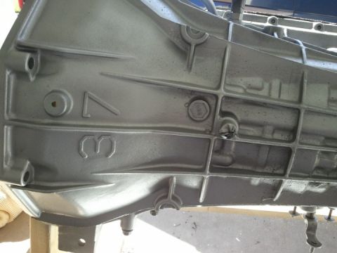1994 Ford Bronco - Close-up of a transmission housing showing cast numbers '7B' and '3'.