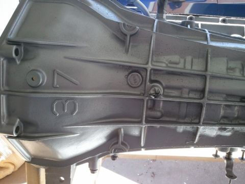 1994 Ford Bronco - Close-up of a transmission case showing cast numbers and bolt details.