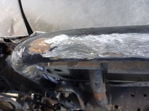 1997 Ford Ranger - Undercarriage view of a damaged metal tube, likely part of a frame or support structure.
