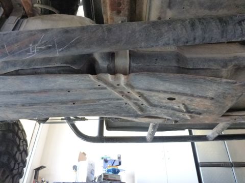 1997 Ford Ranger - The underside of a truck, revealing the fuel tank and frame, with a visible tire on the left.