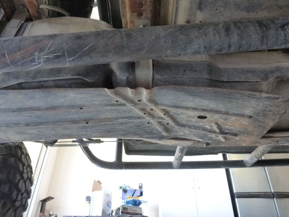 Underbody of a truck showing fuel tank and frame components