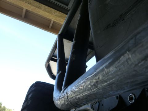 1997 Ford Ranger - Detail of a roll bar and tire, possibly from an off-road vehicle.