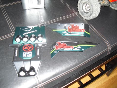 1986 Ford Bronco - Model car body panels with 'Twin Hammers' branding and racing number 15 are laid out on a dark surface.