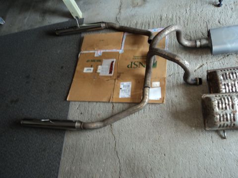 2004 Mercury Grand Marquis - Vehicle exhaust system components laid out on a concrete surface.