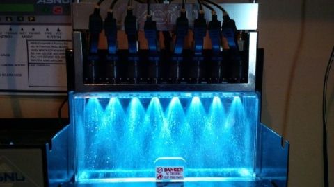 1965 Ford Fairlane - This machine tests and cleans fuel injectors, spraying them with a blue fluid.