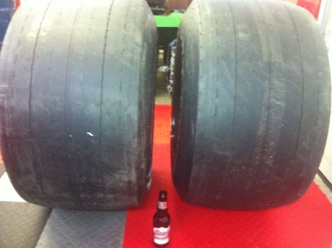1965 Ford Fairlane - Two large, worn racing tires are shown with a beer bottle for scale.