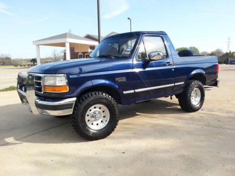 1995 Ford Bronco - This 1995 Ford Bronco is shown from the front three-quarter view with a bright blue paint job.