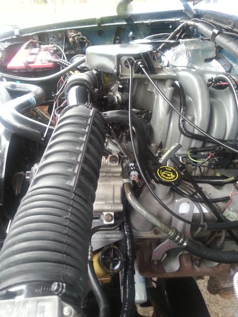 1995 Ford Bronco - Close-up view of the engine compartment, showing the air intake system and other mechanical parts.