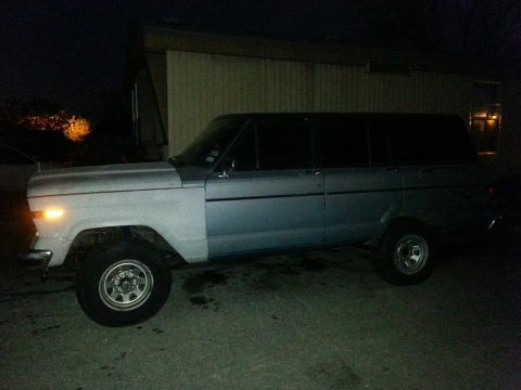 1982 Jeep Wagoneer - A 1982 Jeep Wagoneer is seen parked outdoors at night, showing a two-tone paint scheme.