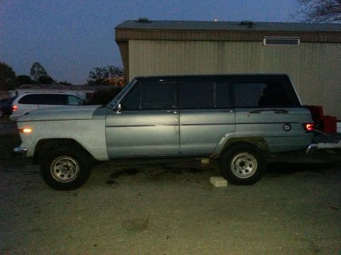 1982 Jeep Wagoneer - Side profile of a light blue 1982 Jeep Wagoneer with a black roof.