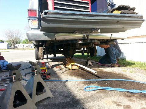 1982 Jeep Wagoneer - Working on the rear axle of a 1982 Jeep Wagoneer, supported by jack stands.