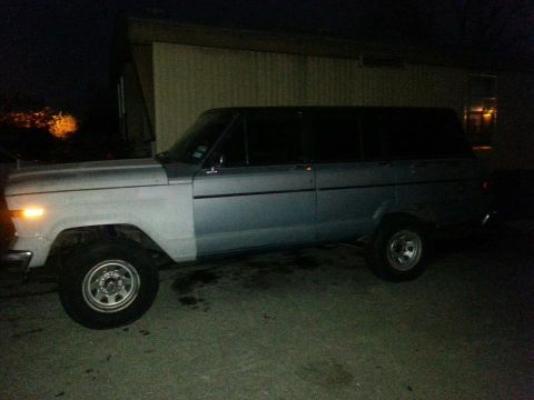 1982 Jeep Wagoneer - Side profile of a 1982 Jeep Wagoneer captured in low light conditions.