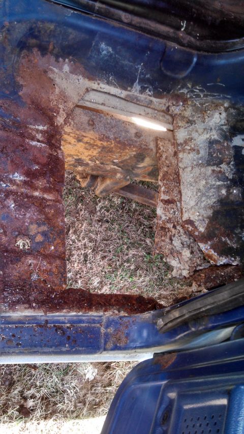 1979 Ford Bronco - Severe rust damage visible on the interior floor pan of a vehicle.