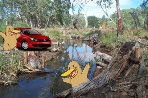 1989 Ford Bronco - A red Volkswagen Golf is positioned near a stream in a wooded area, accompanied by cartoon ducks.