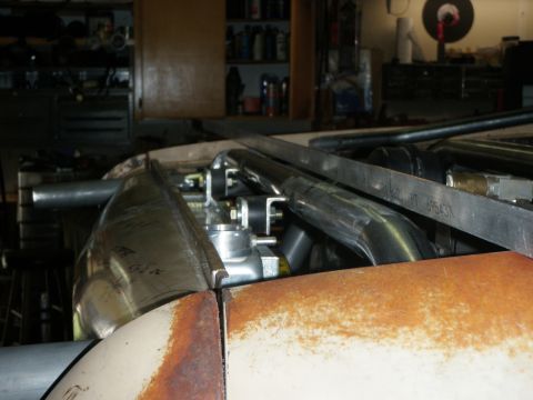 1961 International Scout 800 - Custom metalwork and exhaust components visible in the engine bay of a vehicle under construction.