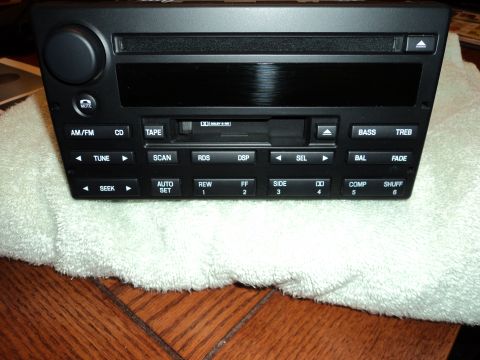 2004 Mercury Grand Marquis - This is a car stereo unit with various controls for radio, CD, and tape functions.