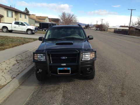2005 Ford Sport Trac - A black 2005 Ford Sport Trac is parked on a residential street, facing the camera.