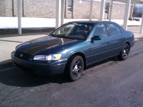 1998 Toyota Camry - This 1998 Toyota Camry sedan is shown from a 3/4 front angle, highlighting its dark teal paint.